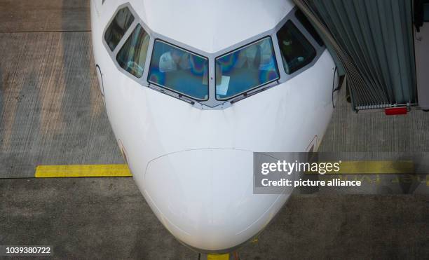 Pilots of a Lufthansa Airbus A320 prepare for the flight in the cockpit early in the morning at the airport in Frankfurt am Main, Germany, 19 March...