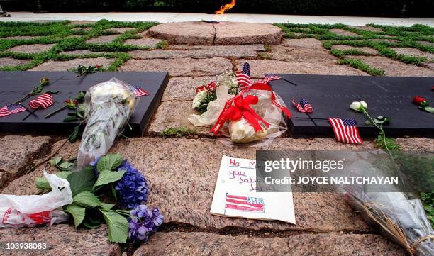 "We miss you John John" is written on a piece of paper left at the gravesite of the assassinated US President John F. Kennedy at Arlington National...