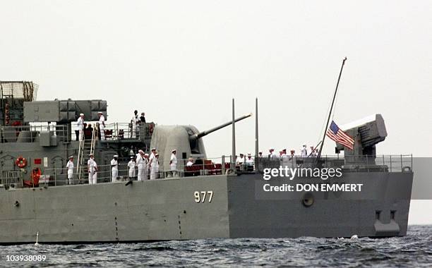 The flag is raised to half mast during funeral services for John Kennedy Jr., Carolyn Bessette Kennedy and her sister Lauren Kennedy aboard the Navy...