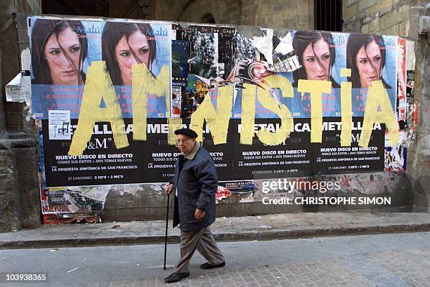 Man passes grafitti saying "amnistia" a reference to ETA members in jail, in the streets of Bilbao, Basque country in northern Spain 29 November 1999...