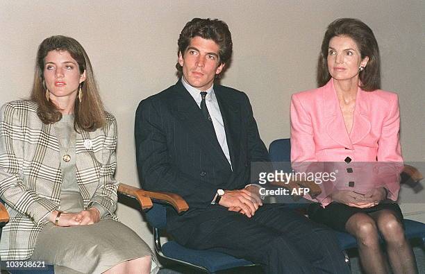 Jacqueline Kennedy Onassis sits with her children Caroline Kennedy Schlossberg and John F. Kennedy Jr during a press conference at the John F....
