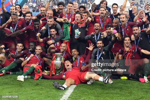 Players of Portugal celebrates after winning the UEFA EURO 2016 soccer Final match between Portugal and France at the Stade de France, Saint-Denis,...