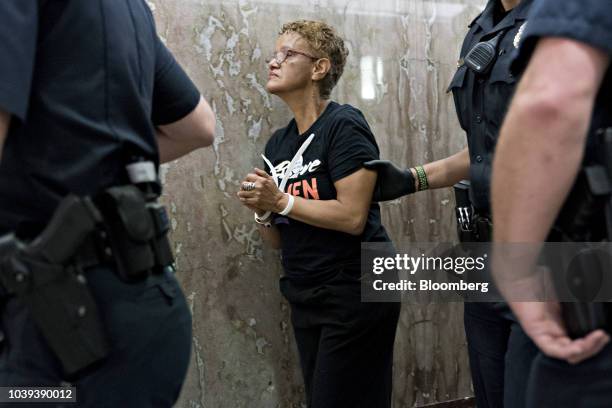 Demonstrator opposed to the Supreme Court nominee Brett Kavanaugh is detained by U.S. Capitol police near the office of Senator Susan Collins, a...