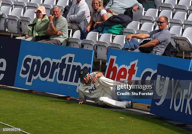 Notts fielder Paul Franks crashes into the ad boards during day three of the LV County Championship division one match between Nottinghamshire and...