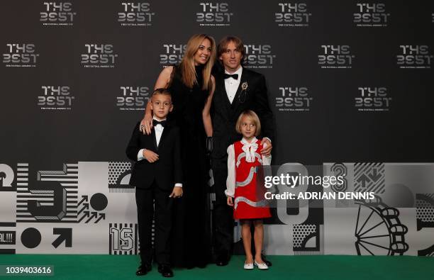 Real Madrid and Croatia midfielder Luka Modric poses with his wife Vanja and their children Ivano and Ema as they arrive for The Best FIFA Football...