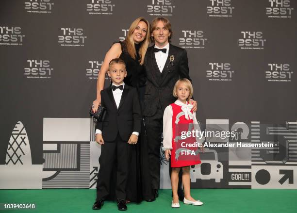 Real Madrid and Croatia midfielder Luka Modric poses with his wife Vanja and their children Ivano and Ema at the Green Carpet during The Best FIFA...