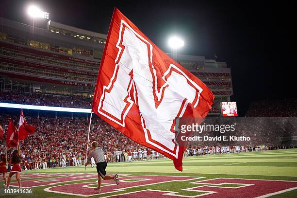 Nebraska cheerleader with flag on field during game vs Western Kentucky. Lincoln, NE 9/4/2010 CREDIT: David E. Klutho
