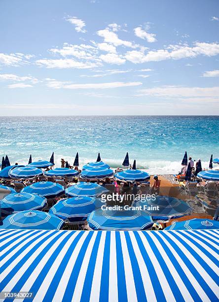 view of mediterranean and beach umbrellas - costa azzurra foto e immagini stock