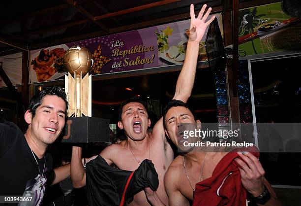 Supporters of Liga Desportiva Universitaria Quito celebrate victory over Estudiantes on the streets of Quito after a final match as part of the...