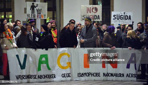 Protesters hold a banner which reads 'Vaterlose Alkoholiker gegen Islamohobie Nationalisten Aersche' during a demonstration against the regional...