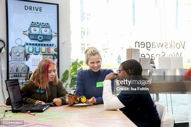 Former German swim olympic gold medalist Britta Steffen with two Arche kids during the kids workshop 'Driven by Kids' hosted by Volkswagen AG at...