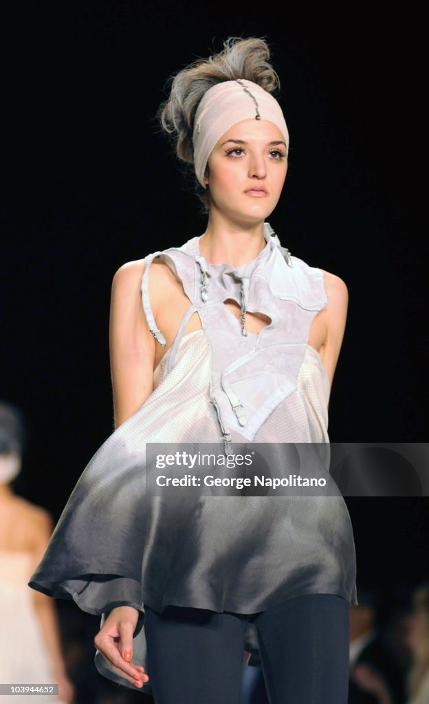 A model walks the runway wearing an April Johnston design at the ...