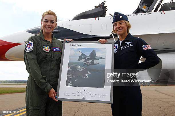 Paula Creamer, 2010 Women's US Open Champion, is presented with a photograph by Kristin "Mother" Hubbard after flying in an F-16 with the U.S. Air...