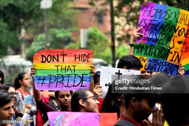 Students of Motilal Nehru College hold placards as they participate in a Pride March at Motilal Nehru College, South Campus on September 24, 2018 in...