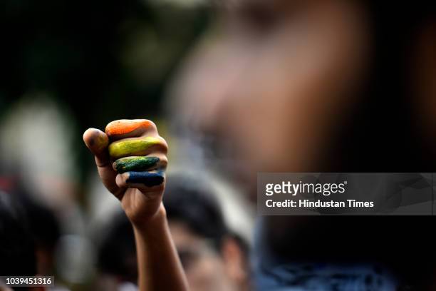 Student raises his hand during a Pride March at Motilal Nehru College, South Campus on September 24, 2018 in New Delhi, India.