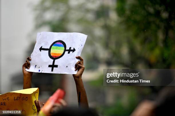 Students of Motilal Nehru College hold placards as they participate in a Pride March at Motilal Nehru College, South Campus on September 24, 2018 in...