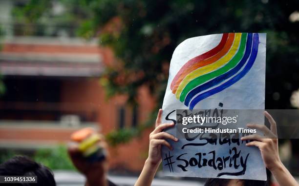 Students of Motilal Nehru College hold placards as they participate in a Pride March at Motilal Nehru College, South Campus on September 24, 2018 in...