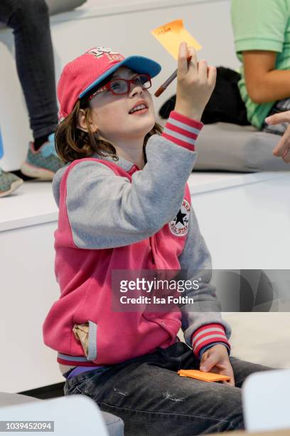 An Arche kid during the kids workshop 'Driven by Kids' hosted by Volkswagen AG at DRIVE Volkswagen Group Forum on September 24, 2018 in Berlin,...