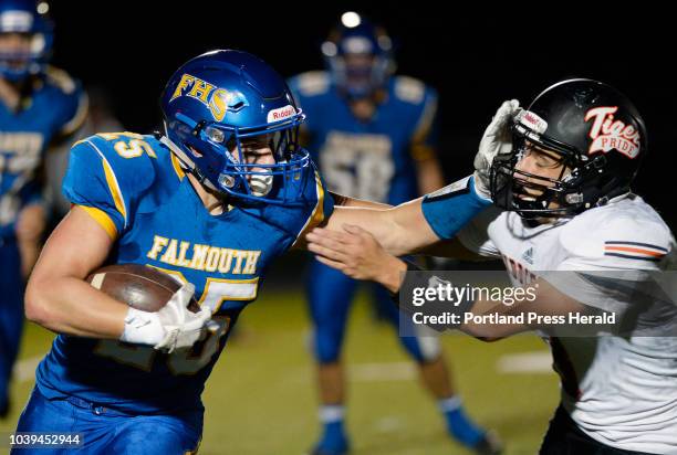 Falmouth's Bradley Douglas tries to elude Biddeford's Scott Kelley Friday, September 21, 2018.