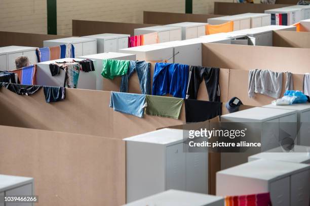 Refugees pictured in a former gymnasium on the grounds of a reception facility for asylum seekers in Regensburg, Germany, 25 September 2015. Metal...