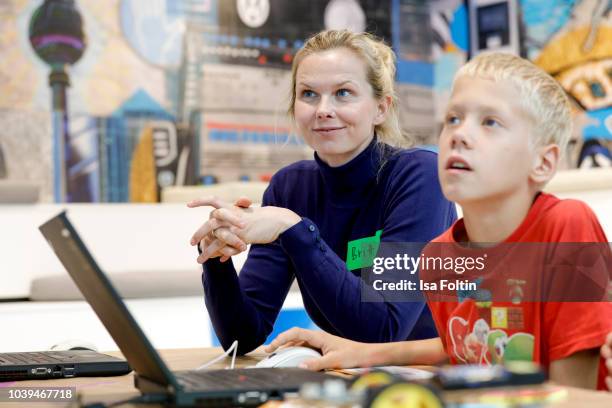 Former German swim olympic gold medalist Britta Steffen and an Arche kid during the kids workshop 'Driven by Kids' hosted by Volkswagen AG at DRIVE...