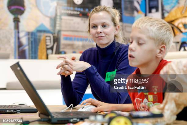 Former German swim olympic gold medalist Britta Steffen and an Arche kid during the kids workshop 'Driven by Kids' hosted by Volkswagen AG at DRIVE...