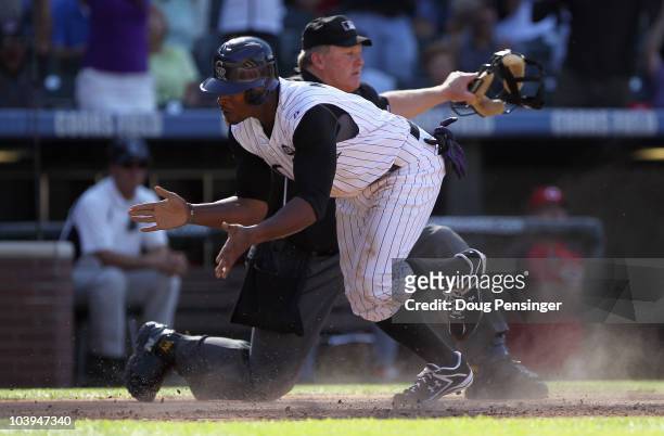 Chris Nelson of the Colorado Rockies steals home and is called safe by homeplate umpire Bill Miller to score the game winning run in the eighth...