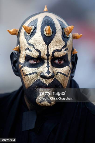 Fan of the New Orleans Saints shows support for his team by painting his face like "Darth Maul" prior to the Saints playing against the Minnesota...