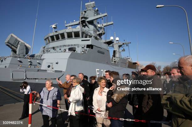 Relatives of crew members of the corvette 'Braunschweig' stand at the naval base in Warnemuende, Germany, 15 April 2013. The corvette heads for...