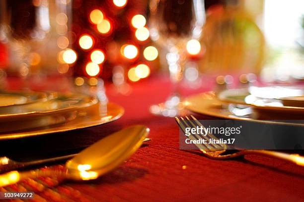 christmas table setting - decorative tablecloth and flatware - red tinsel stock pictures, royalty-free photos & images