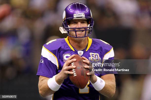 Quarterback Brett Favre of the Minnesota Vikings smiles as he warms up against the New Orleans Saints at Louisiana Superdome on September 9, 2010 in...