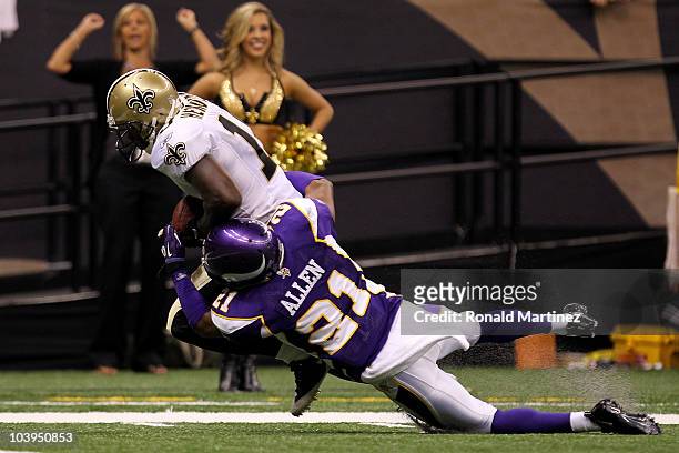 Devery Henderson of the New Orleans Saints scors a 29-yard touchdown reception in the first quarter against Asher Allen of the Minnesota Vikings at...