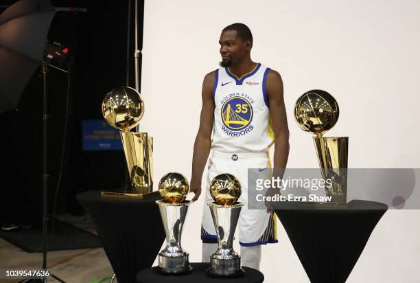 Kevin Durant of the Golden State Warriors poses with two Larry O'Brien NBA Championship Trophies and two NBA Finals MVP trophies during the Golden...