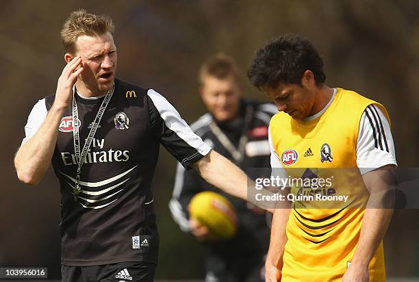 Nathan Buckley the assistant coach of the Magpies speaks to Paul Medhurst during a Collingwood Magpies AFL training session at Gosch's Paddock on...