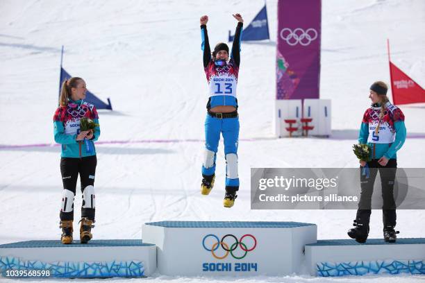 Second placed Anke Karstens of Germany , gold medal winner Julia Dujmovits of Austria and third placed Amelie Kober of Germany celebrates during the...