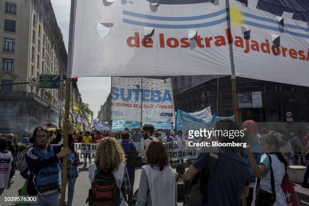 Demonstrators hold banners and gather during a protest organized by Argentine Workers' Central Unit in Buenos Aires, Argentina, on Monday, Sept. 24,...