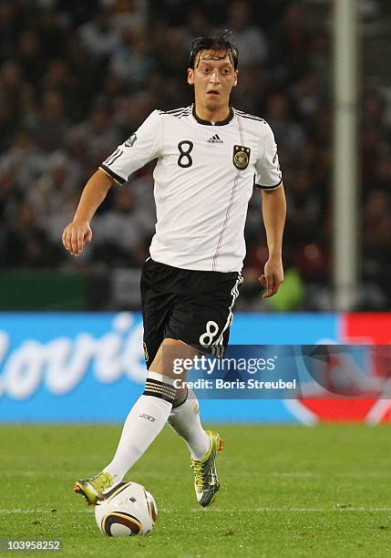 Mesut Oezil of Germany runs with the ball during the EURO 2012 Group A Qualifier match between Germany and Azerbaijan at RheinEnergie stadium on...