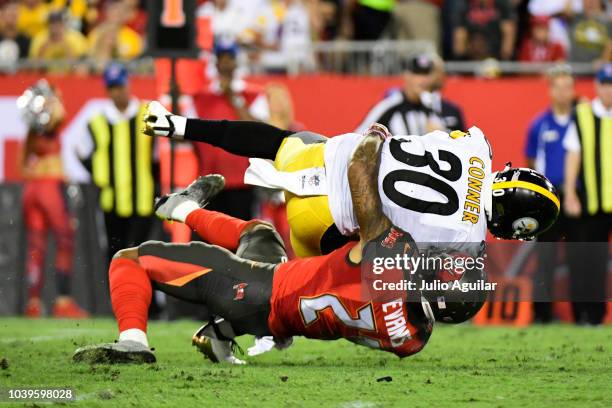 Justin Evans of the Tampa Bay Buccaneers wraps up James Conner of the Pittsburgh Steelers in the first quarter against the Pittsburgh Steelers on...