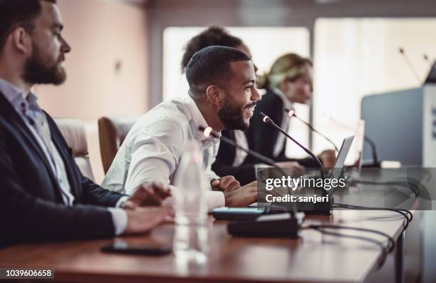 business people listening to the speaker at a conference - team presentation press conference training womens international stock pictures, royalty-free photos & images