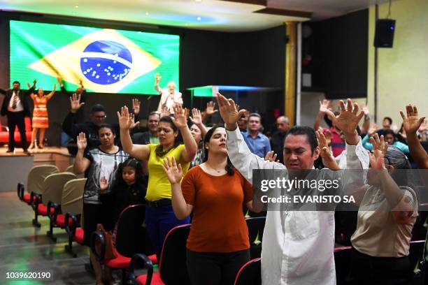 Faithful pray at an evangelical church in Brasilia, on September 21, 2018 for the recovery of the health of Brazilian right-wing presidential...