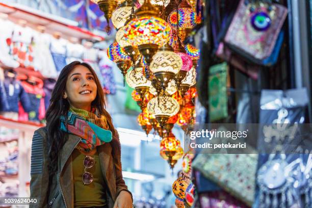 beautiful young woman shopping in grand bazaar, istanbul, turkey - istanbul bazaar stock pictures, royalty-free photos & images