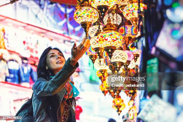 beautiful young woman shopping in grand bazaar, istanbul, turkey - travel cultures stock pictures, royalty-free photos & images