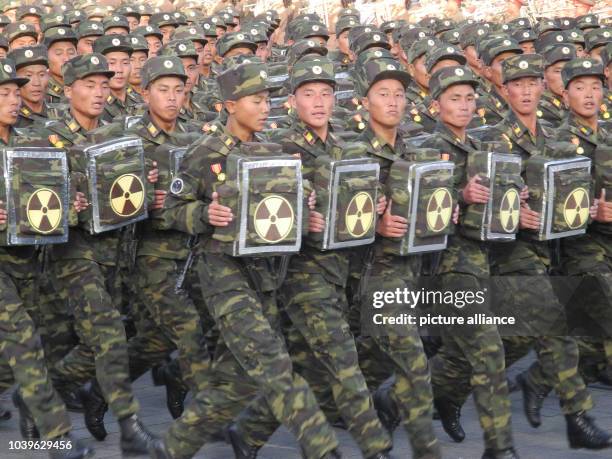 Soldiers march during the military parade for the 70th anniversary of the founding of the ruling workers' party on Kim Il-Sung Square in Pyongyang,...