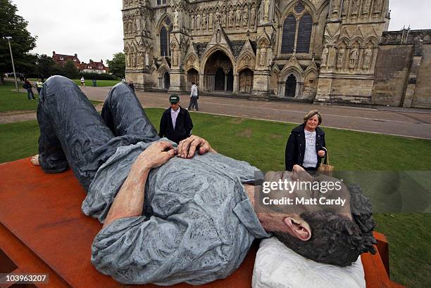 Visitors to Salisbury Cathedral admire Sean Henry's sculpture Catafalque which is being displayed as part of the Cathedral's Liminality exhibition on...