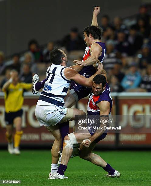 James Podsiadly of the Cats attempts to mark between Luke McPharlin and Antoni Grover of the Dockers during the AFL Second Semi Final match between...