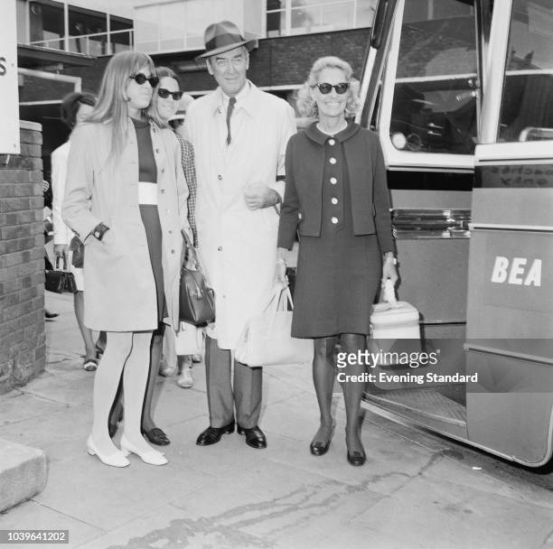 American actor and military officer James Stewart with his wife, American actress and fashion model Gloria Hatrick McLean , and daughters Judy and...