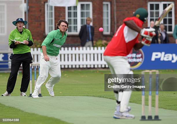 Former New Zealand cricketer Lou Vincent of Herbert Smith bowls to former England cricketer Devon Malcolm of UBS during the Save the Children Charity...