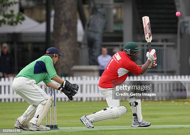 Former England cricketer Devon Malcolm of UBS drives during the Save the Children Charity Match during the Save the Children Charity Cricket Day held...