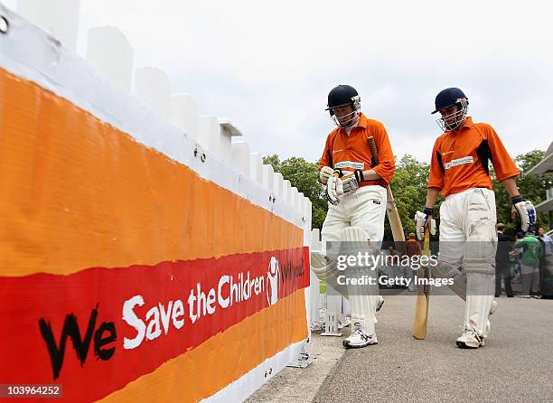 The opening batsmen for Hogan Lovells walk out to bat during the London Corporate Cup Final between Urban Projects and Hogan Lovells during the Save...