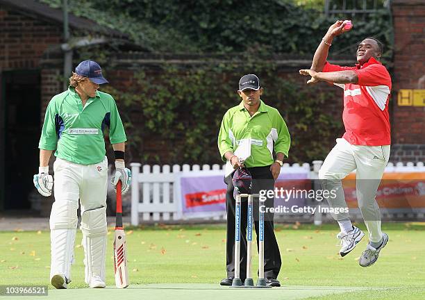 Former England cricketer Devon Malcolm of UBS bowls with former New Zealand cricketer Lou Vincent of Herbert Smith looking on during the Save the...